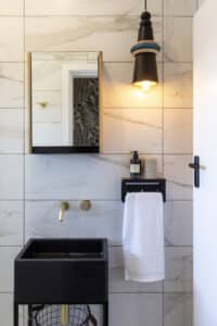Some of Modern Gesture's signature lighting pieces used to decorate a beautiful bathroom